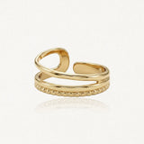Bague ajustable en acier inoxydable doré, avec une bande formant une boucle, une lisse et une perlée.