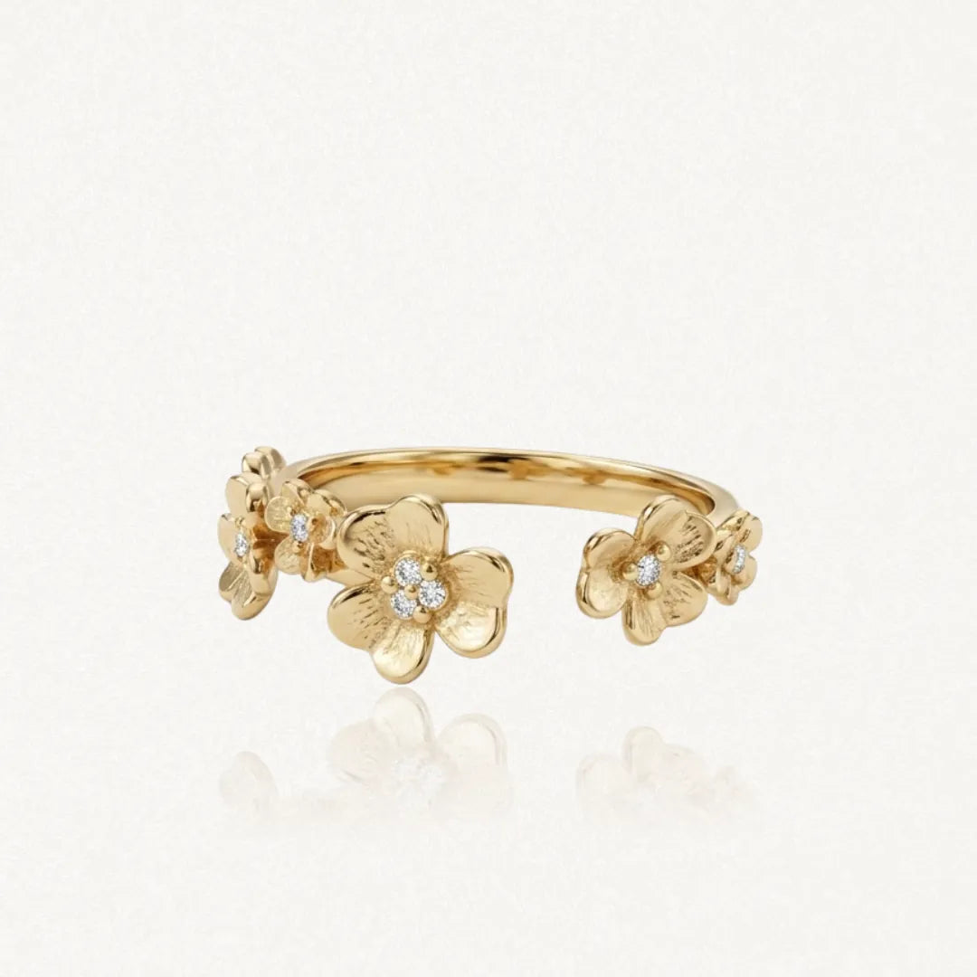 Bague ouverte en acier inoxydable doré, ornée de plusieurs fleurs de différentes tailles avec des strass Zirconium.