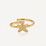 Bague ajustable en acier inoxydable doré, ornée d'une étoile de mer texturée et granulée.