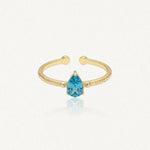 Bague Leandra ouverte en acier inoxydable doré avec une pierre bleue en forme de goutte et une texture martelée
