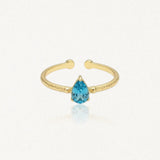 Bague Leandra ouverte en acier inoxydable doré avec une pierre bleue en forme de goutte et une texture martelée