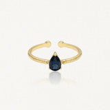 Bague Leandra ouverte en acier inoxydable doré avec une pierre bleue en forme de goutte au centre