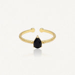 Bague Leandra en acier inoxydable doré avec une pierre noire en forme de goutte et un anneau à la texture martelée