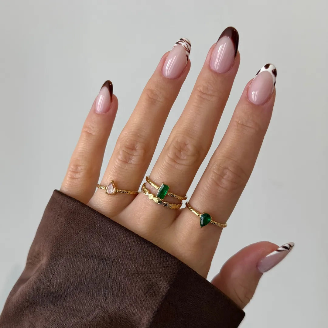 Bague Leandra en acier inoxydable doré avec un strass en zirconium vert en forme de poire sur un anneau fin