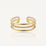 Bague ajustable en acier inoxydable doré, composée de trois anneaux : un rang central de billes et deux rangs lisses.