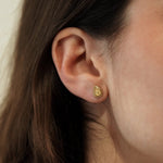 Femme portant une paire de puces d'oreilles en Acier Inoxydable et Agate Blanche MAISON DE L'AMOUR en forme de goutte.