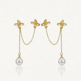 Deux boucles d'oreilles doubles en acier inoxydable doré, avec deux fleurs reliées par une chaîne, et une perle blanche