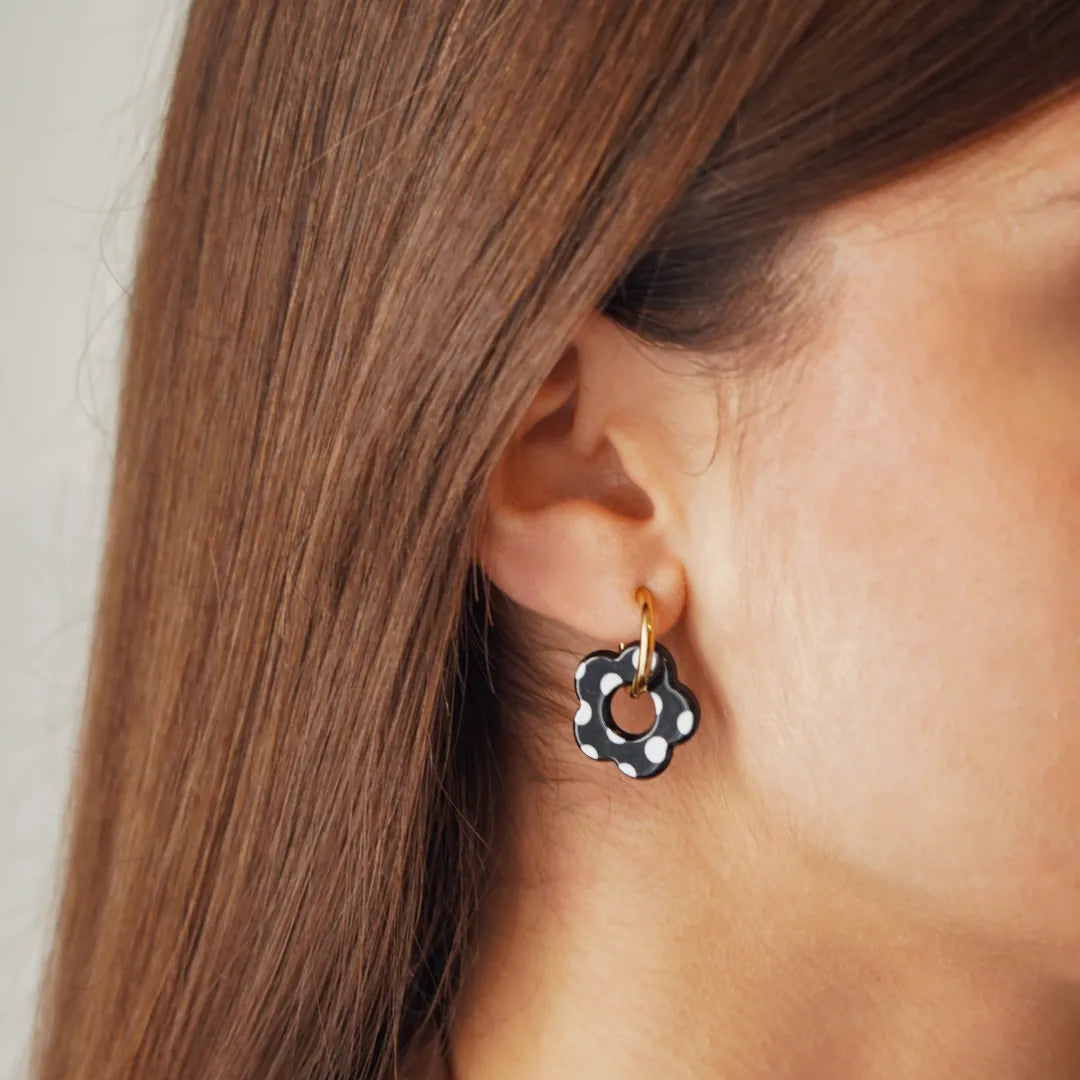 Boucles d'oreilles Lena en acier inoxydable doré avec un pendentif en forme de fleur noire à pois blancs