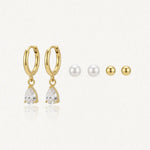 Trio de boucles d'oreilles: créoles acier inoxydable doré avec zirconium poire, puces perles et puces acier inoxydable doré.