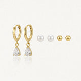 Trio de boucles d'oreilles: créoles acier inoxydable doré avec zirconium poire, puces perles et puces acier inoxydable doré.