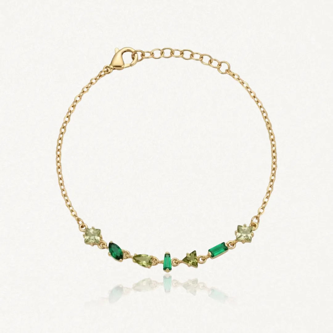 Bracelet Blair en acier inoxydable doré orné de plusieurs strass de tailles et de nuances de vert variées