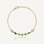 Bracelet Blair en acier inoxydable doré orné de plusieurs strass de tailles et de nuances de vert variées