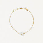 Bracelet en acier inoxydable doré avec chaîne perlée blanche et fleur de nacre.