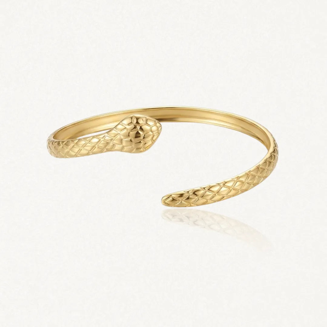 Bracelet jonc serpent ouvert en acier inoxydable doré, à double tête sculptée.