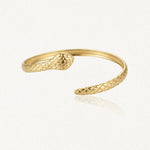 Bracelet jonc serpent ouvert en acier inoxydable doré, à double tête sculptée.