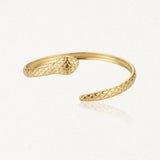 Bracelet jonc serpent ouvert en acier inoxydable doré, à double tête sculptée.