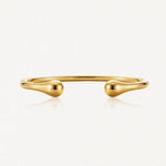 Bracelet jonc ouvert doré, poli et brillant, aux extrémités en forme de goutte.