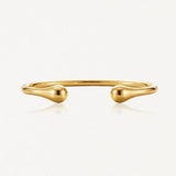 Bracelet jonc ouvert doré, poli et brillant, aux extrémités en forme de goutte.