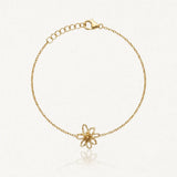 Bracelet fin en acier inoxydable doré, pendentif fleur ajourée cœur granuleux, fermoir mousqueton et chaînette de réglage.