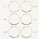 Six bracelets Blair en acier inoxydable doré avec des strass en zirconium de différentes couleurs disposés en ligne