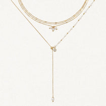 Composition de colliers en acier inoxydable doré: ras-le-cou triple chaîne avec perles irrégulières et collier en Y perlé.