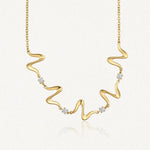 Collier ondulé en acier inoxydable doré avec quatre zircons brillants
