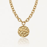 Collier en acier inoxydable doré à chaîne maillons ovales et pendentif rond texturé martelé.