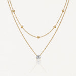 Collier double superposé en acier inoxydable doré avec chaîne à billes et pendentif pierre brillante.