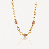 Collier en acier inoxydable doré à gros maillons ovales avec 3 perles facetées rose pâle.