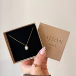 Collier Kendall en acier inoxydable doré avec pendentif ovale orné d'un strass en zirconium dans son coffret cadeau