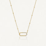 Collier Kylie en acier inoxydable doré avec une chaîne à billes et un pendentif ovale orné de petits strass zircon