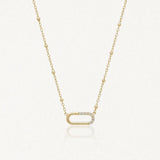 Collier Kylie en acier inoxydable doré avec une chaîne à billes et un pendentif ovale orné de petits strass zircon