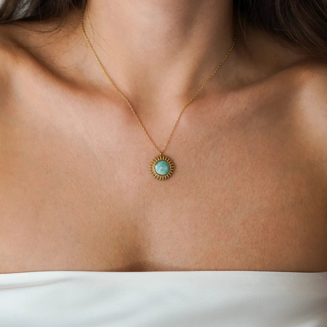 Collier fin en acier inoxydable doré avec pendentif rond soleil et pierre naturelle d'amazonite bleu-vert, porté sur
