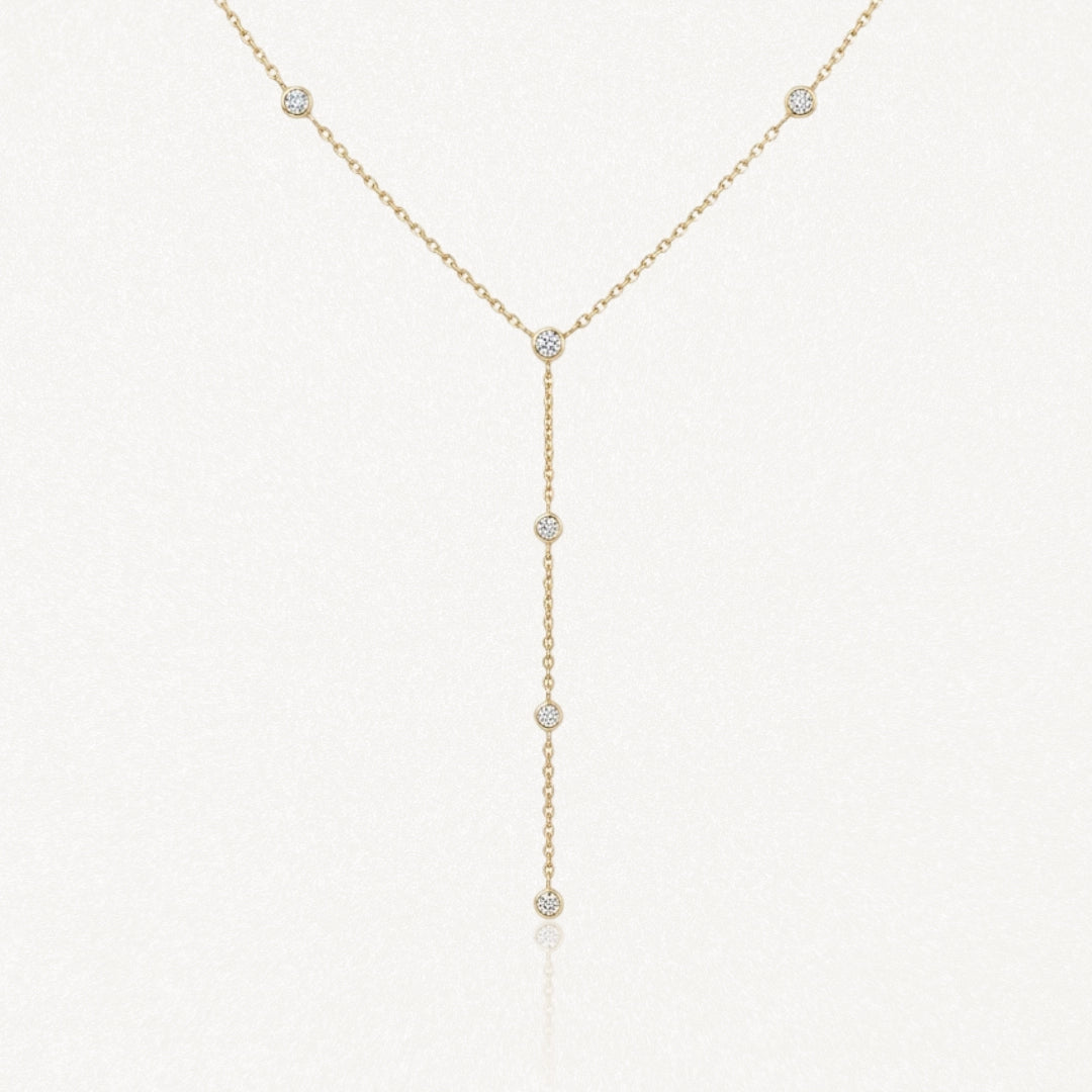 Collier lariat en acier inoxydable doré, chaîne fine ornée de 7 pierres rondes brillantes.