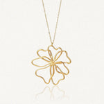 Collier en acier inoxydable dore, pendentif grande fleur ajouree aux petales courbes et stylises.