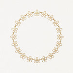 Collier en acier inoxydable doré à maillons fleurs ajourées, formant un cercle.