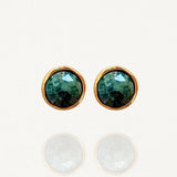 Paire de puces d'oreilles minimalistes MAISON DE L'AMOUR : pierre verte effet émeraude sertie de métal doré sur fond blanc.
